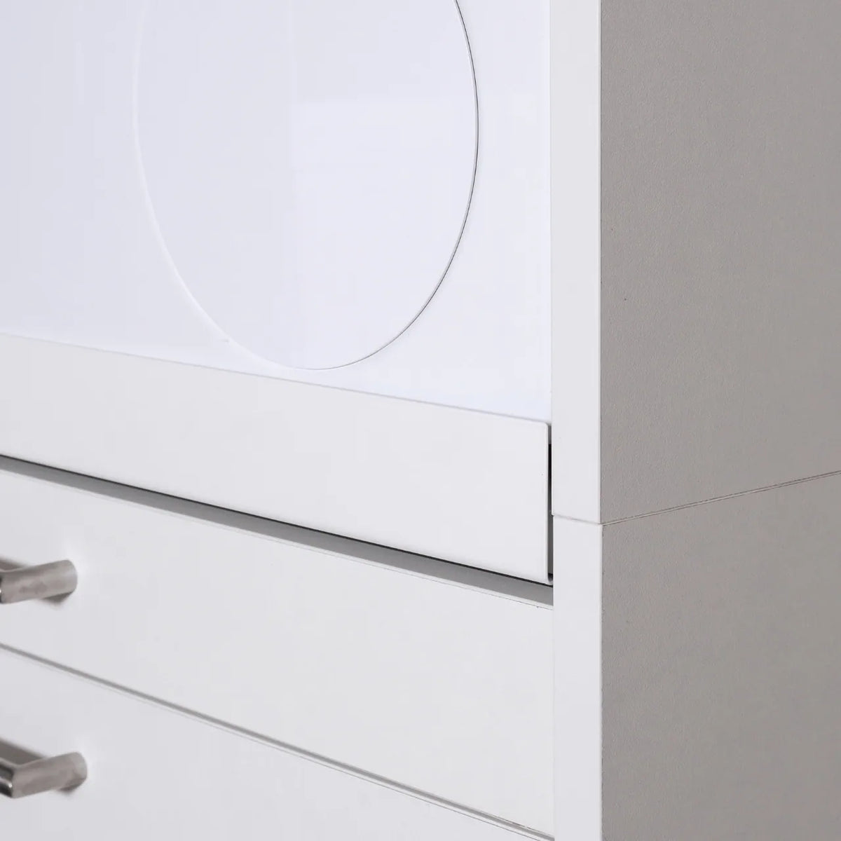 White modern cabinet corner with clean lines and metal handles on drawers.