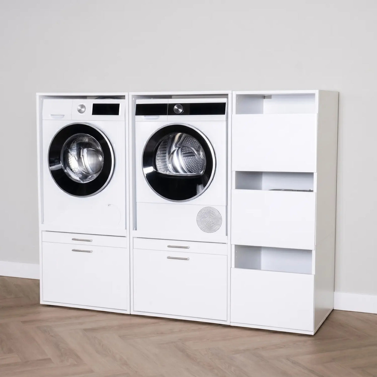 White freestanding laundry unit with front-loading washer, dryer, and open shelving on wood floor.