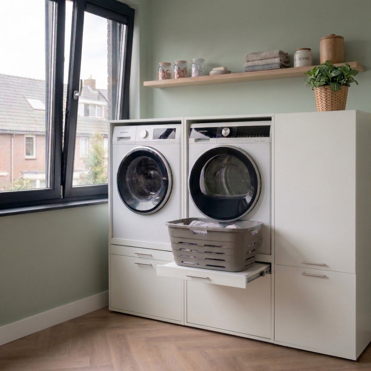 White built-in laundry cabinet with front-load washer and dryer, sliding detergent drawer, and storage shelves above.