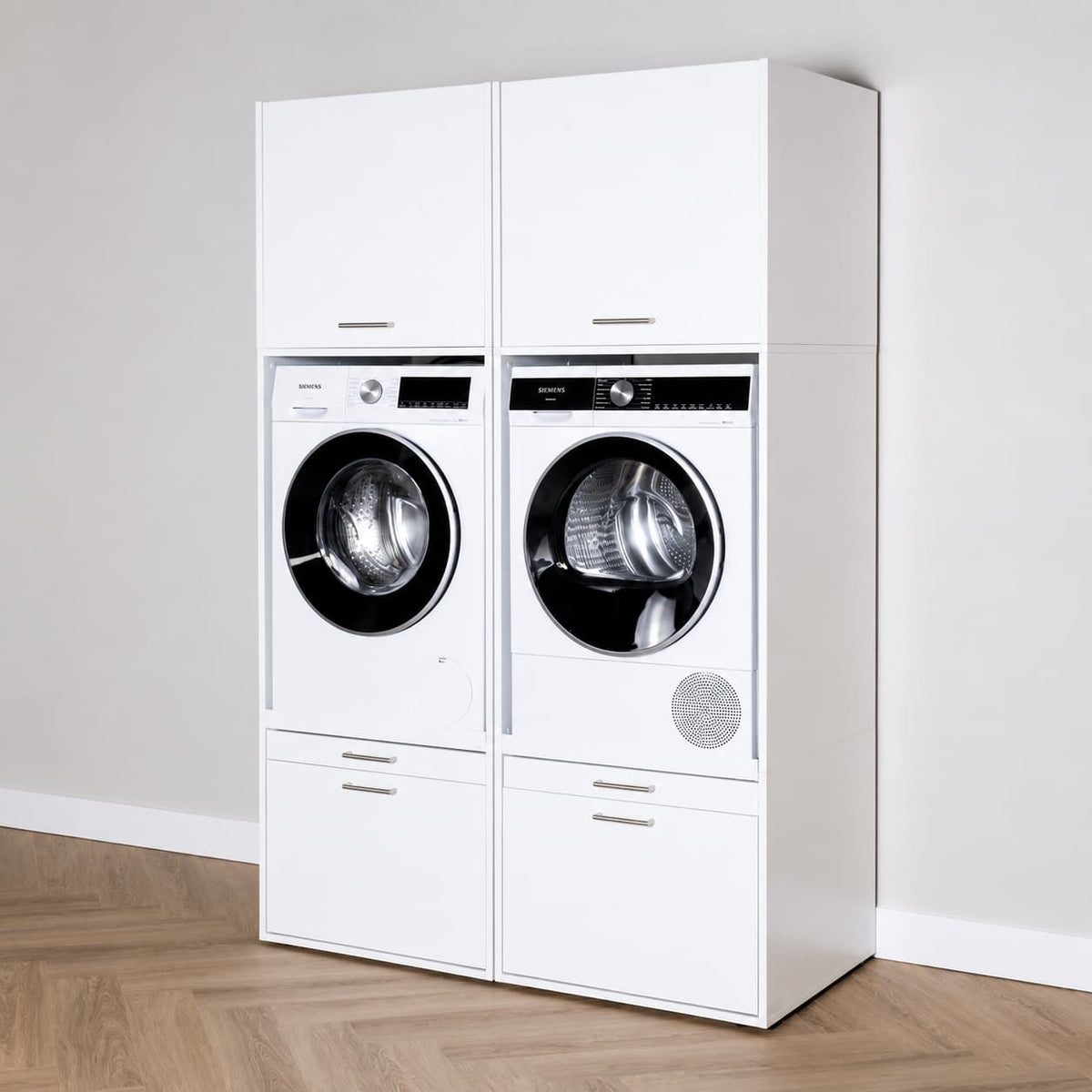 White freestanding laundry cabinet with stacked front-loading washer and dryer, sleek silver handles.