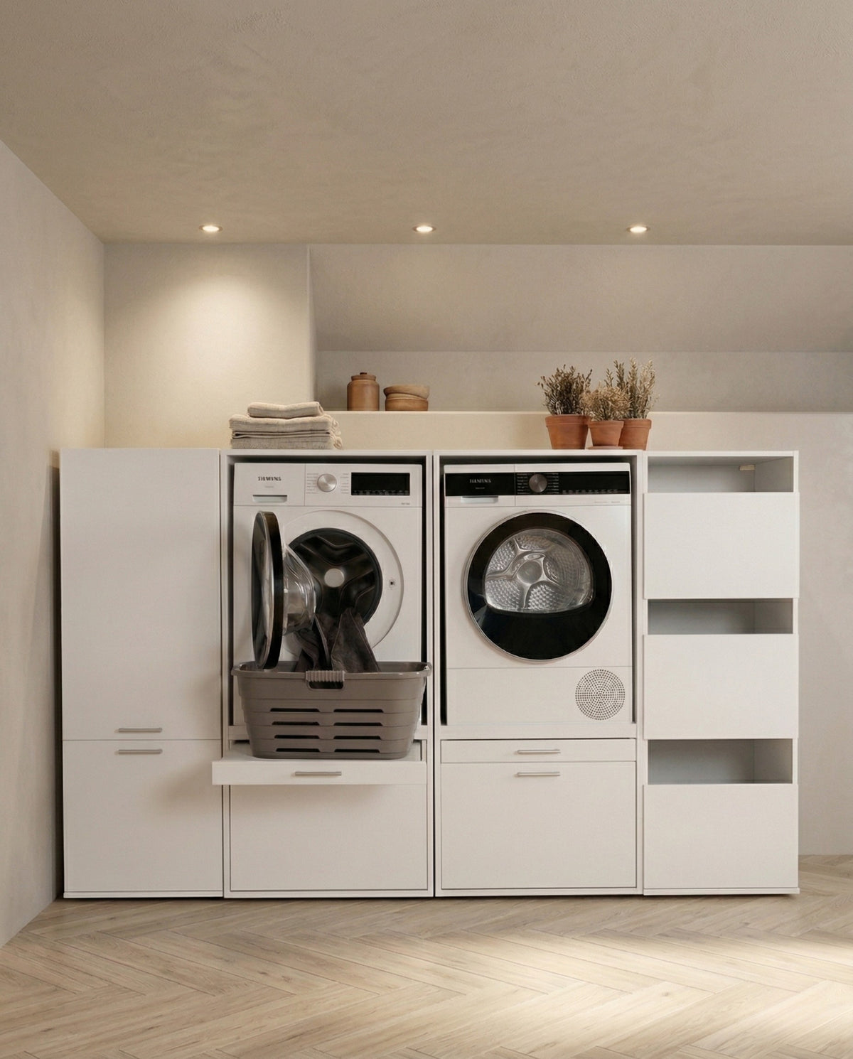 White modern laundry center with front-load washer and dryer, built-in shelving, and storage compartments.