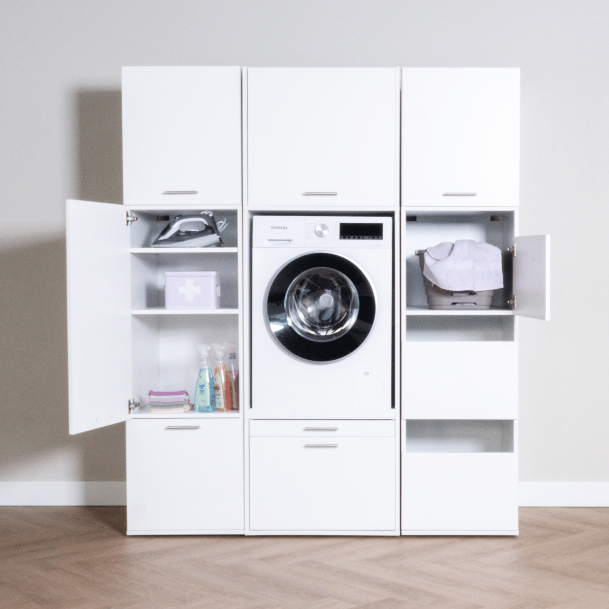 White laundry cabinet set with open compartments, front-load washing machine, and storage shelves.